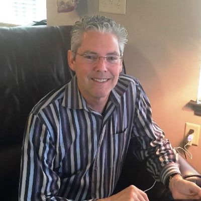 Steve is wearing a glass and shirt with stripes design.